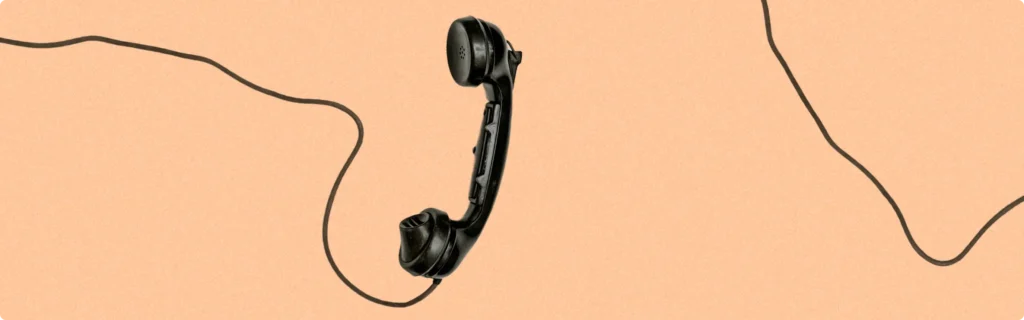 Picture of an old telephone handset on a solid background