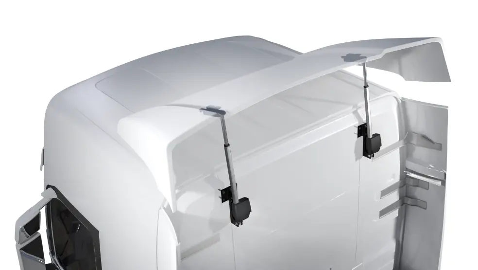 White truck cab with aerodynamic roof spoiler and support struts.