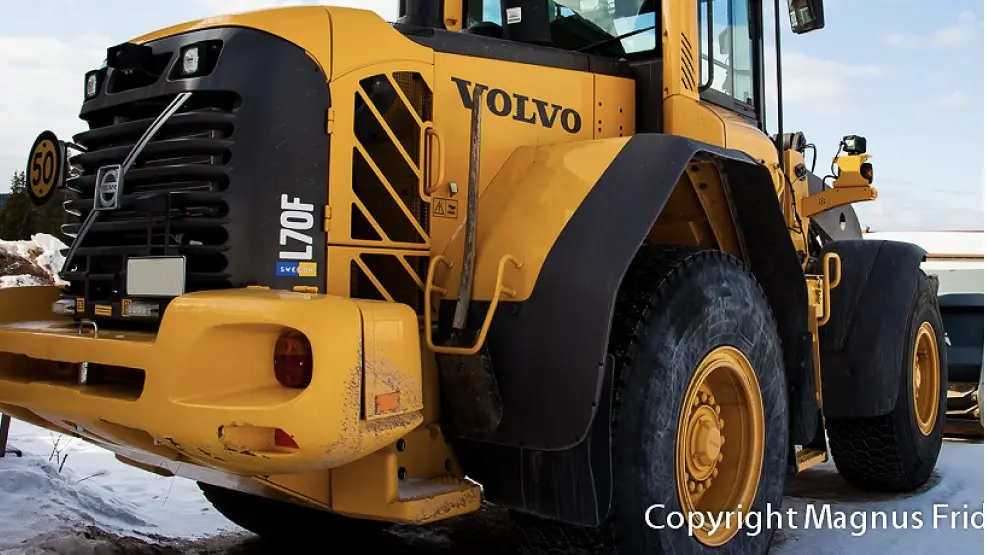 Yellow Volvo L70F wheel loader on a snowy construction site.